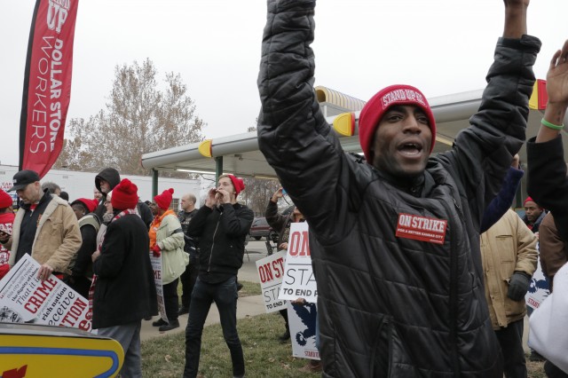 Terrence Wise, a leader in the Stand Up KC movement, gives the "hands up, don't shoot" display while striking for higher wages Thursday afternoon. (photo by Caitlin Cress/Hale Center for Journalism) 
