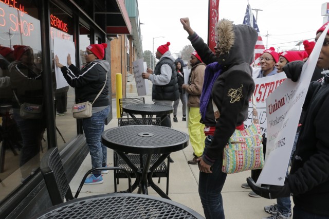 Fast food workers gather outside of a Jimmy John's on Wornall Road, encouraging fellow workers to come out and join their strike. (photo by Caitlin Cress/Hale Center for Journalism)