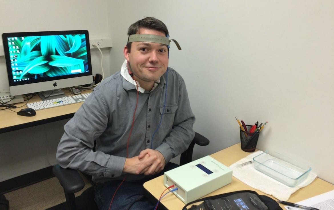 KCUR's Alex Smith tries at transcranial direct current stimulation at the Chrysikou lab at the University of Kansas.