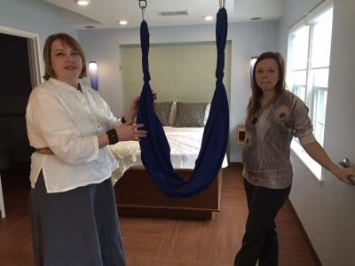 Kendra Wyatt, left, of the New Birth Center in Kansas City, Kansas, and expectant mother Sarah Lockridge inspect a 'birthing sling' in the room that Sarah is hoping to use when she delivers her first baby in a couple of months. (Photo: Jim McLean |Heartland Health Monitor)