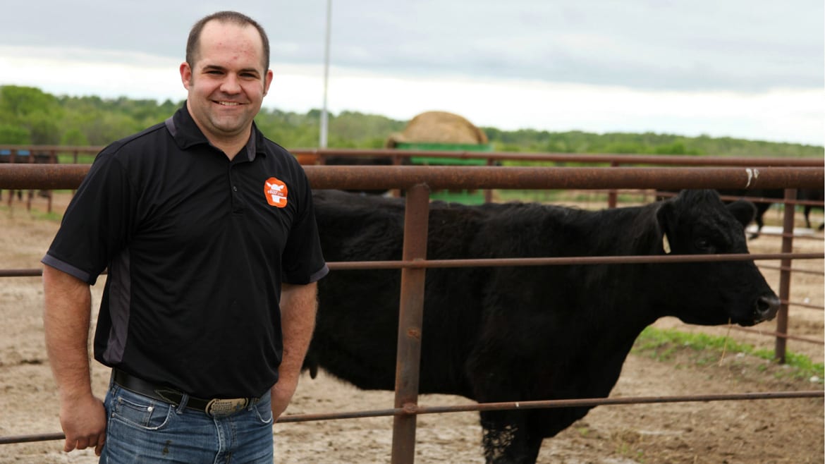A cattle geneticist in front of a cow