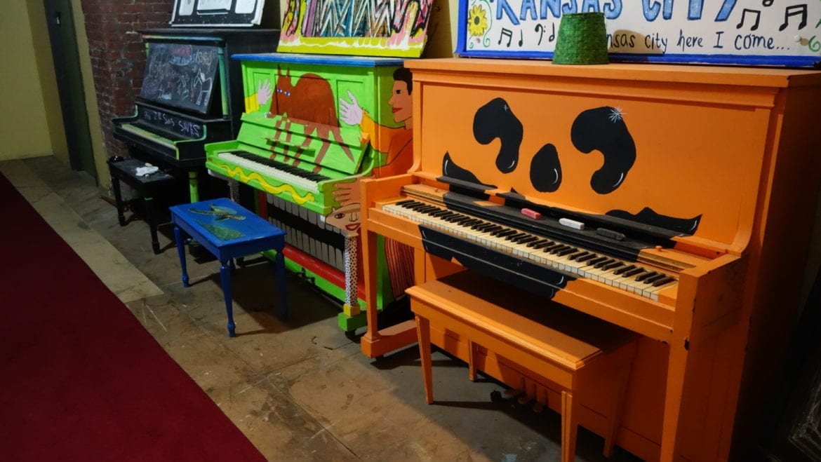 Painted pianos in a line.