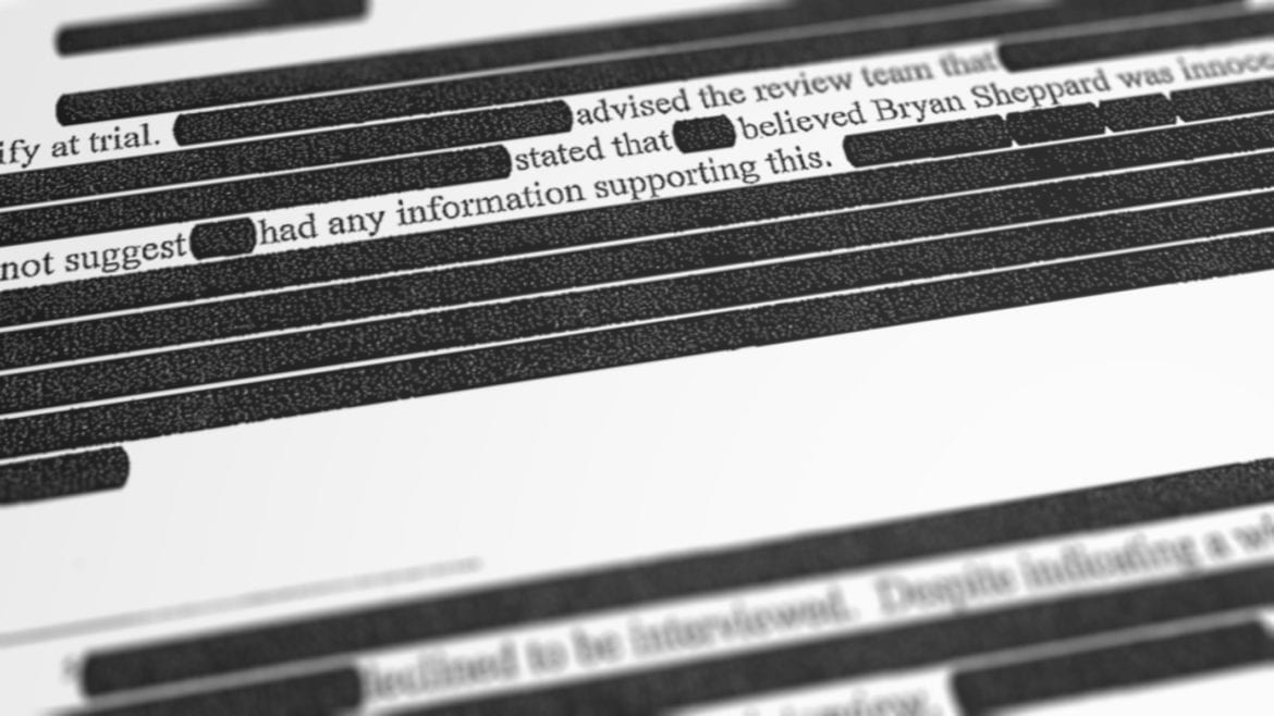 a portion of a heavily redacted report
