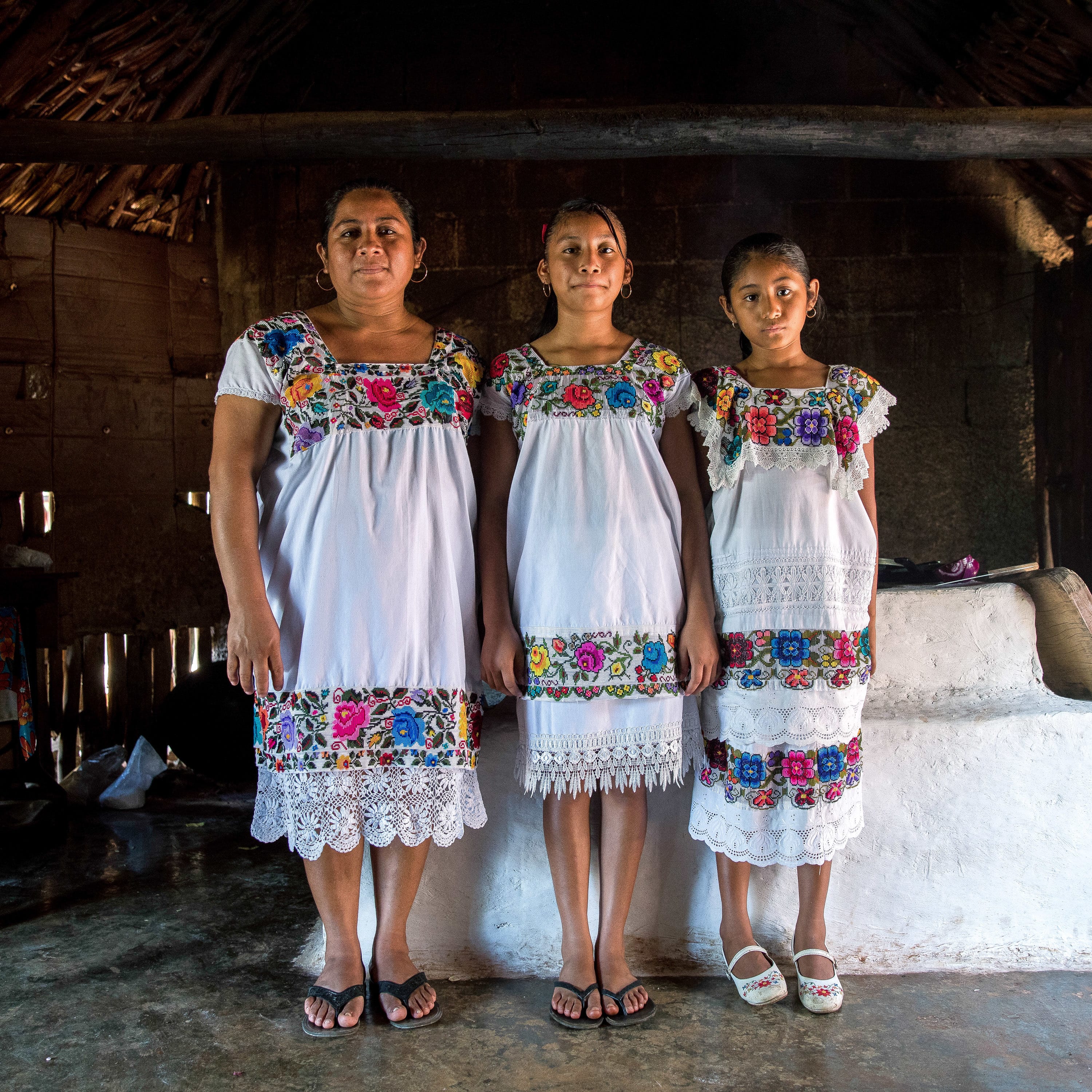 Maria de los Angeles Tun Burgos with daughters Angela, 12, and Gelmy, 9, in their family home in a Maya village in Yucatan, Mexico. Adriana Zehbrauskas for NPR