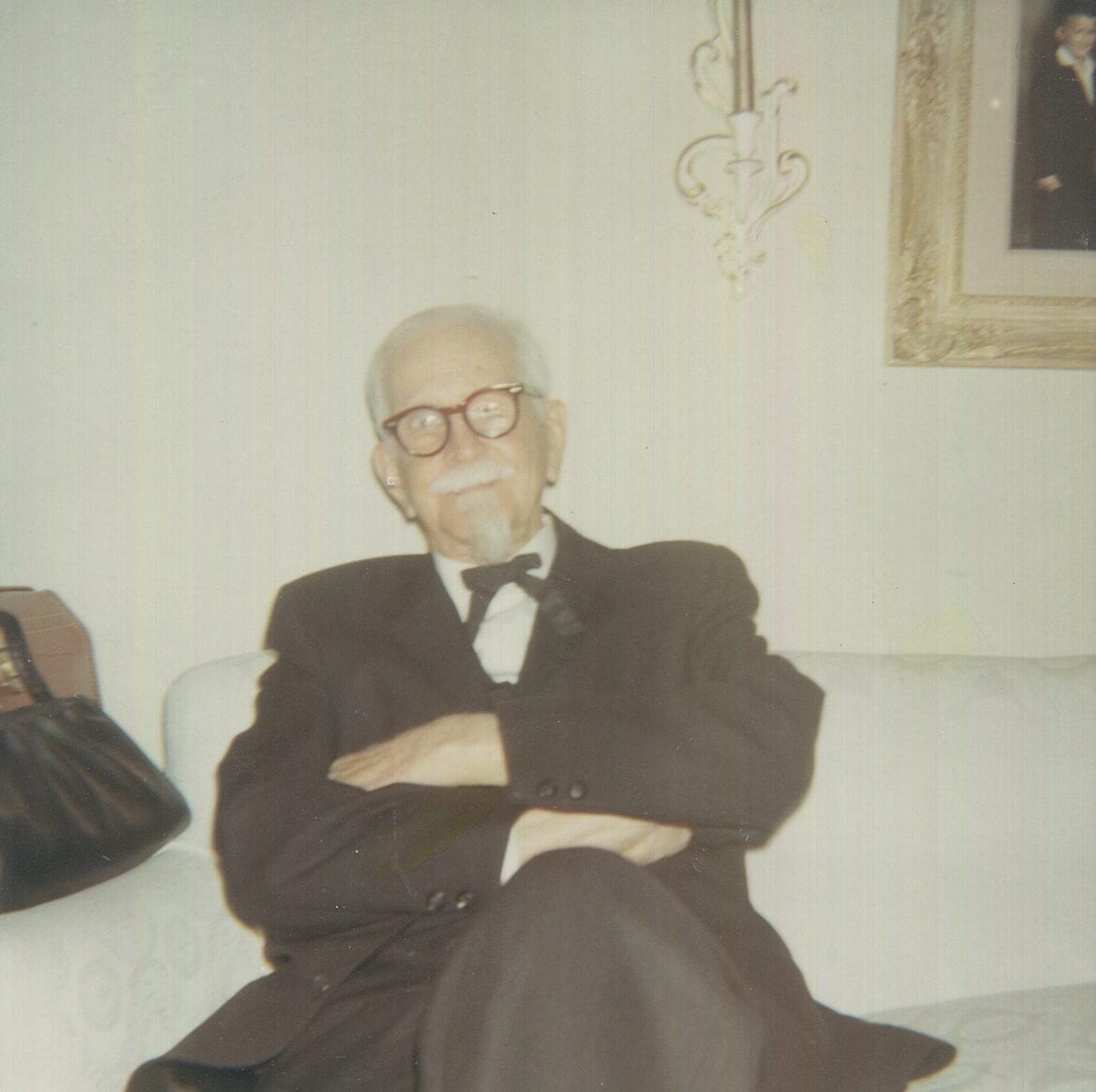An old photo of a man in a living room.