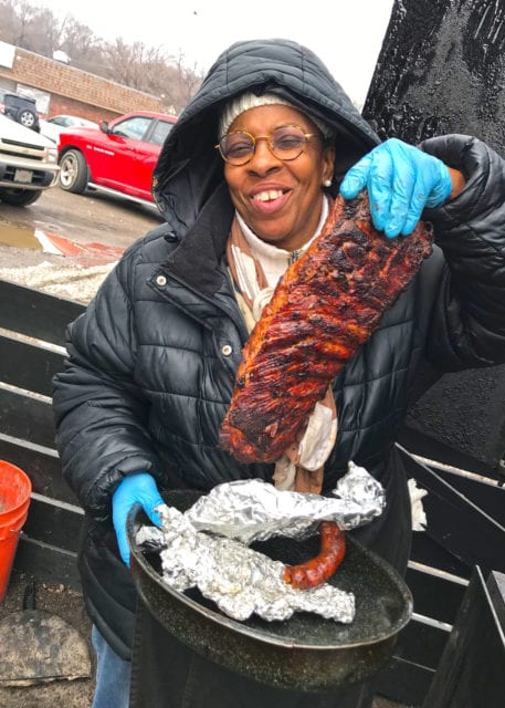 Pitmaster Deborah Jones holds up a rack of ribs 