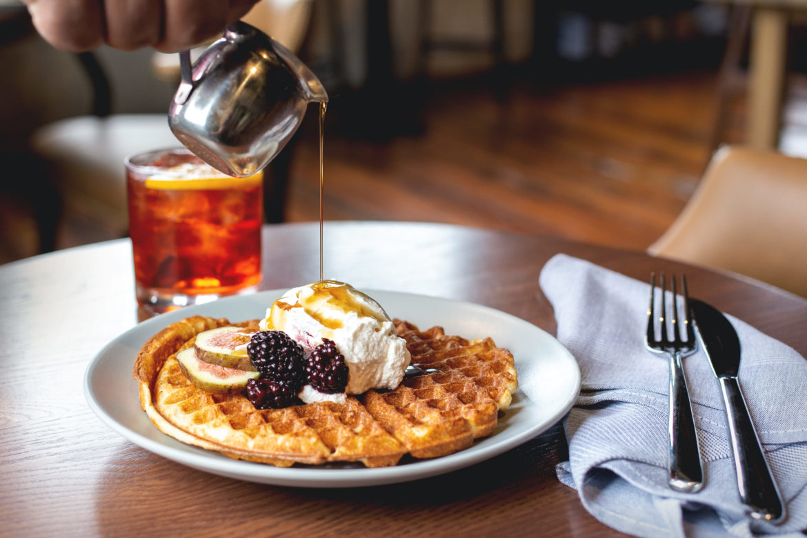 Whiskey syrup is poured over waffles.