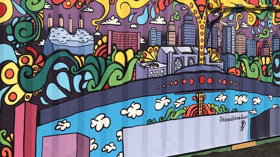 A mural of Kansas City painted on the side of a shipping container.