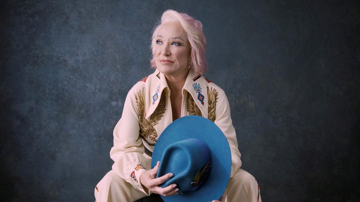 Country music legend Tanya Tucker poses with pink hair. 