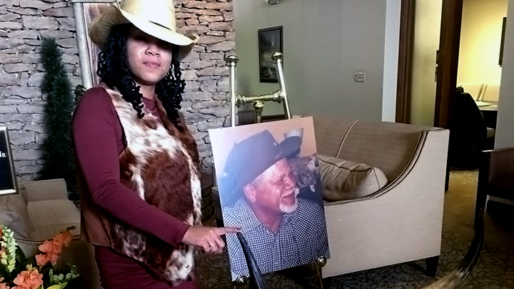 Oralee holds photo of her father, Warren Watkins Jr.