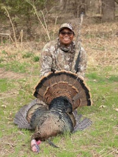 Cierra Black poses with a wild turkey she recently shot in Kansas.