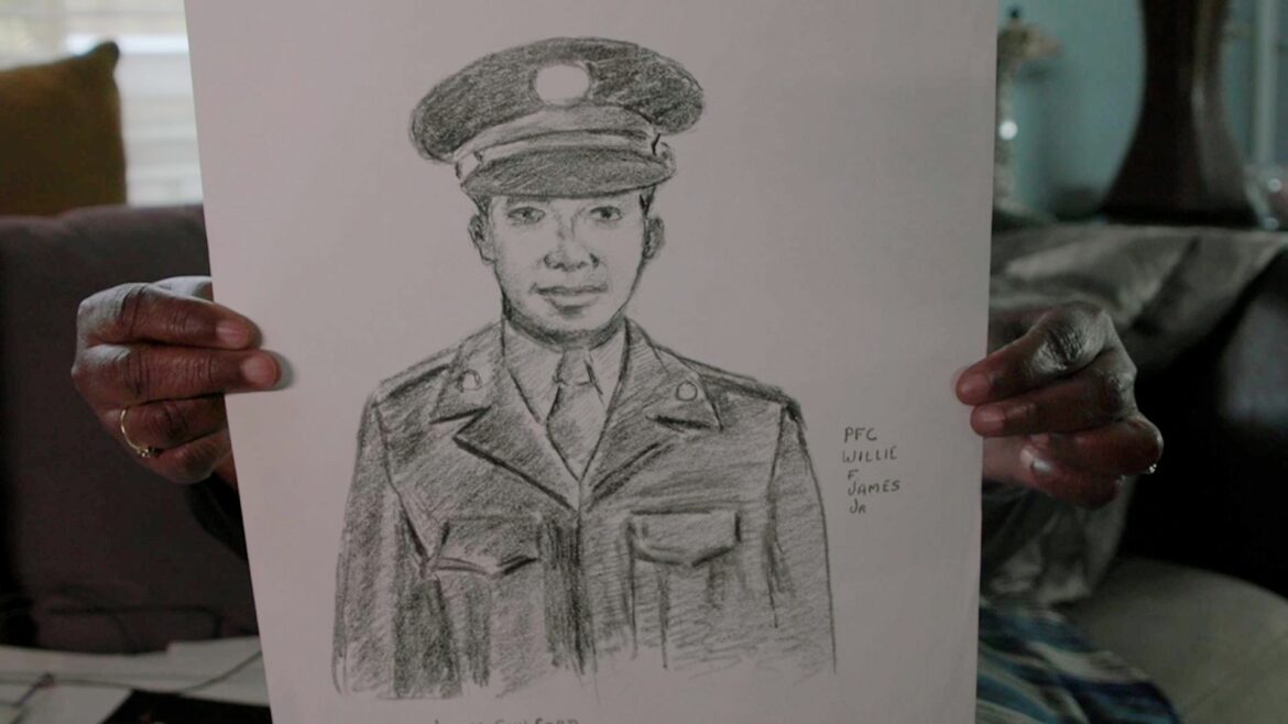 A niece holds up a sketch of Medal of Honor winner Willy F. James Jr.