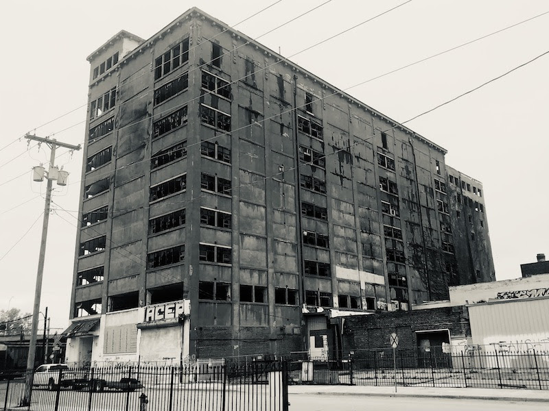 The derelict Weld Wheel Building at 933 Mulberry would ge demolished and replaced with new apartments in a redevelopment plan being pursued by SomeraRoad.
