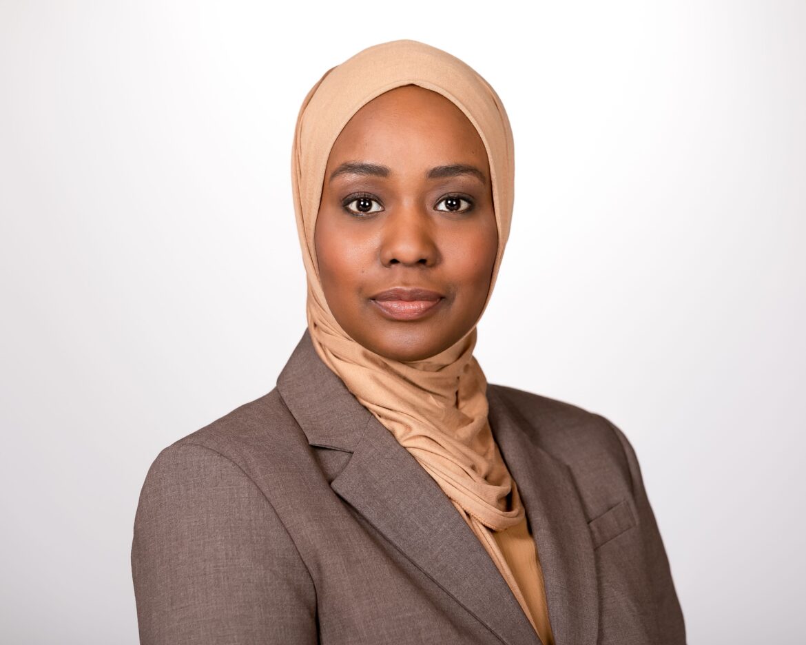 Donning a tan headscarf and brown blazer, Ithar Hassaballah is the Health Equity Evaluation Project Manager at the University of Kansas Medical Center.