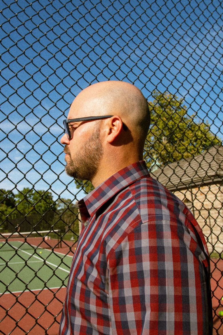 Jose Martí is an electrical engineer by trade and president of the Puerto Rican Society of Great Kansas City by night and weekends. Standing in front of a tennis court is a callback to his father. They'd agreed to get their minds off the hurricane on the court. (Ji Stribling | Flatland)