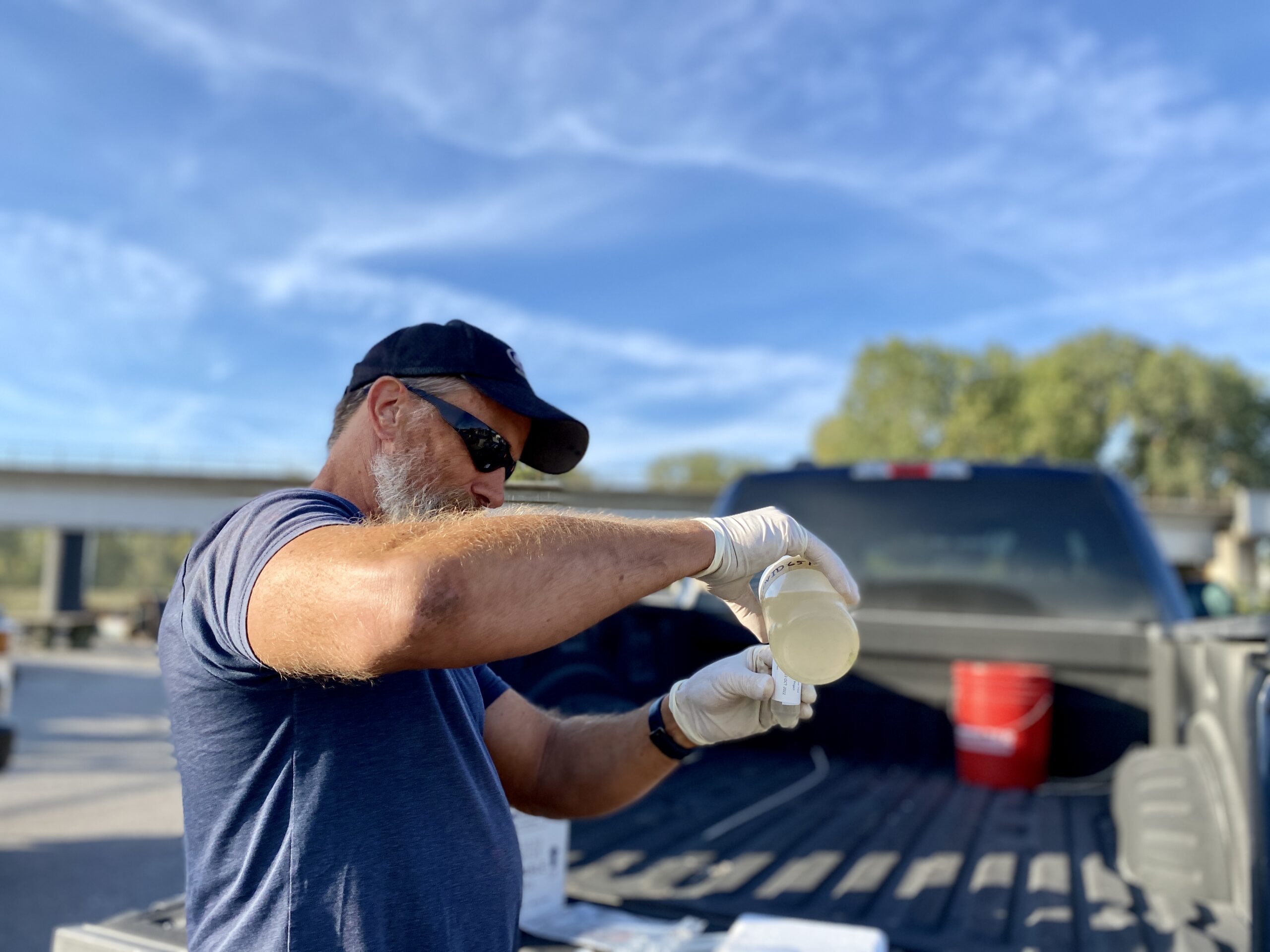 Scott Goins, KC Water's senior plant operator, pours the wastewater into the COVID-19 test tube, which will be shipped to the lab for further testing. (Vicky Diaz-Camacho | Flatland)