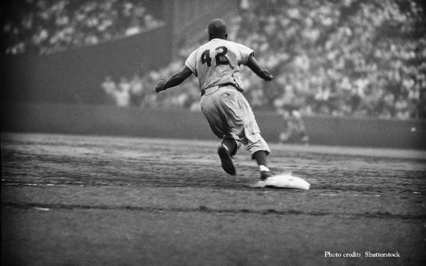 Jackie Robinson rounding first base.