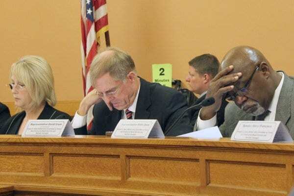panelists looking down during hearing. photo credit Jim McClean