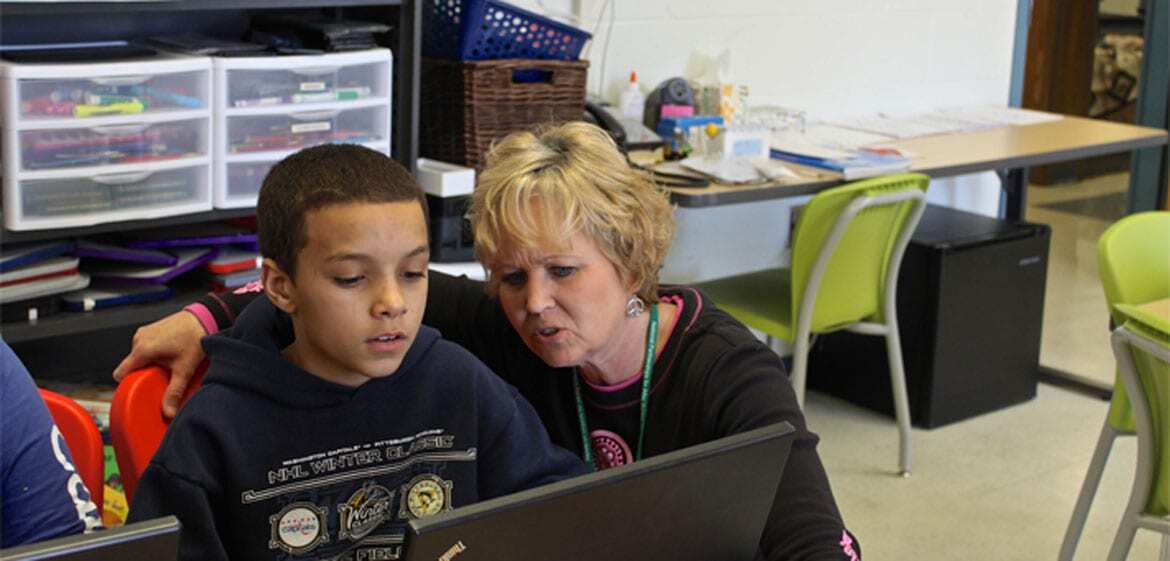 Teacher working with student in Topeka