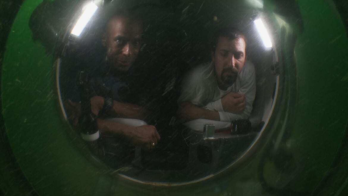 Image of Dr. Lewis and another man in a submarine.