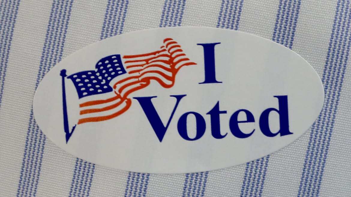 Image of "I Voted" sticker on a striped shirt