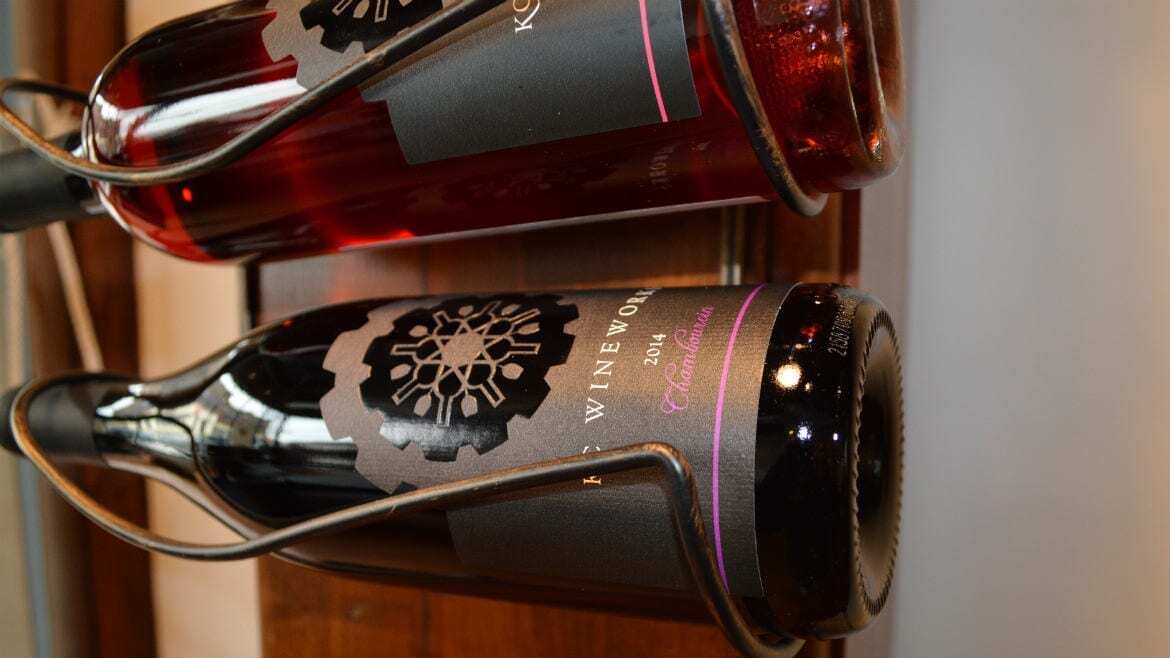 A pair of bottles hang on a wall.