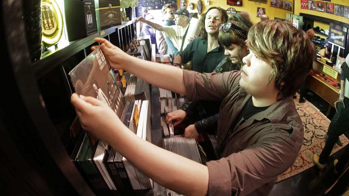 People looking through records at a store