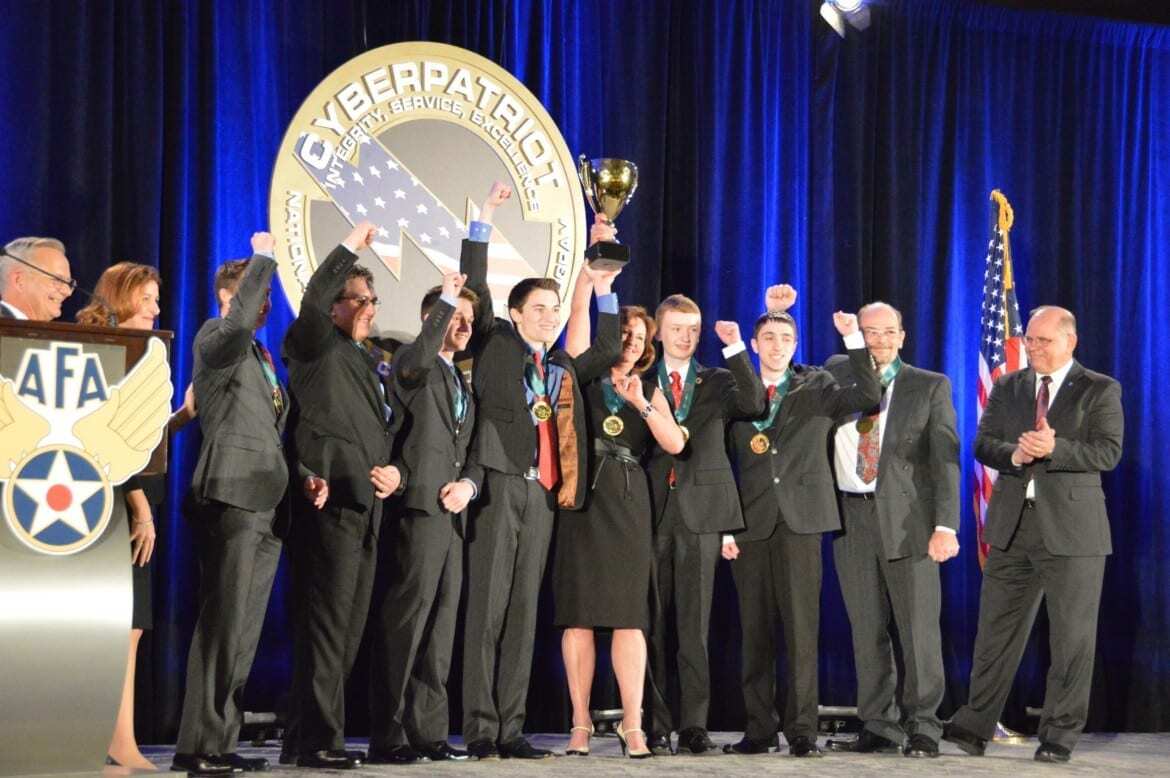 Team hoisting trophy