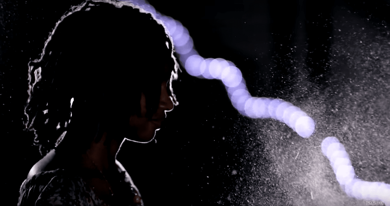 A woman's profile from on stage.