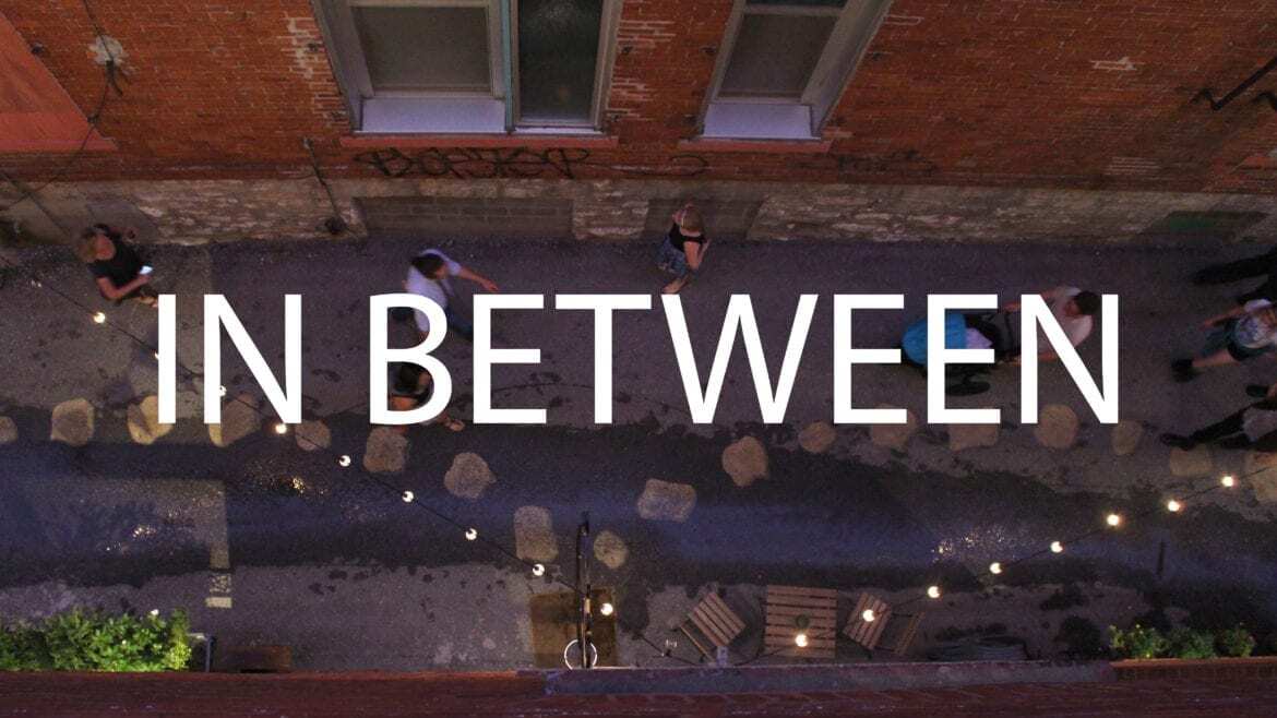 Image of an alley with words In Between written on it