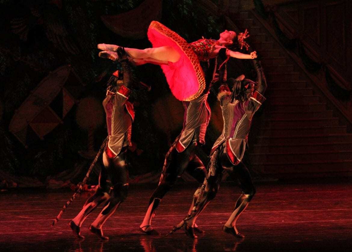 A ballerina being held in the air.