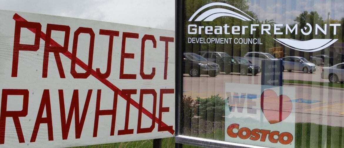 "Project Rawhide" crossed out near a storefront.