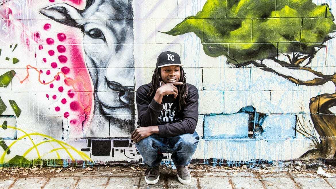 A rapper in front of graffiti