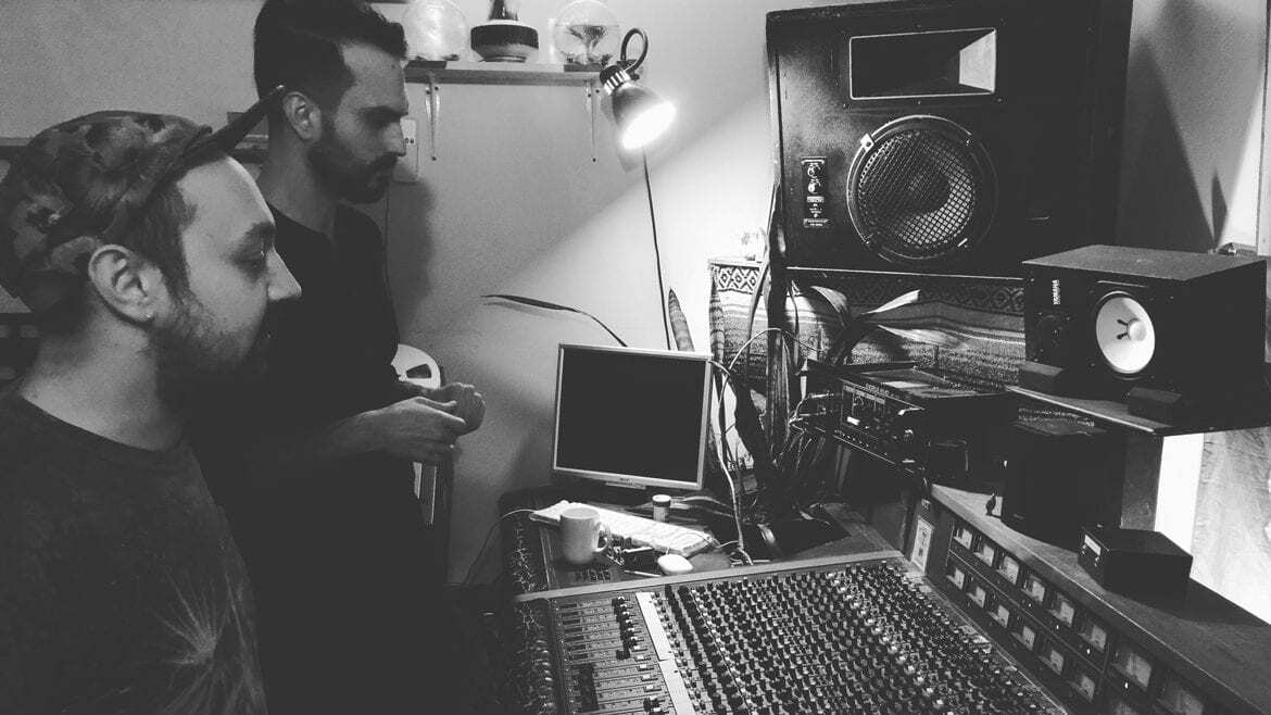 Musician and sound engineer at mixing board