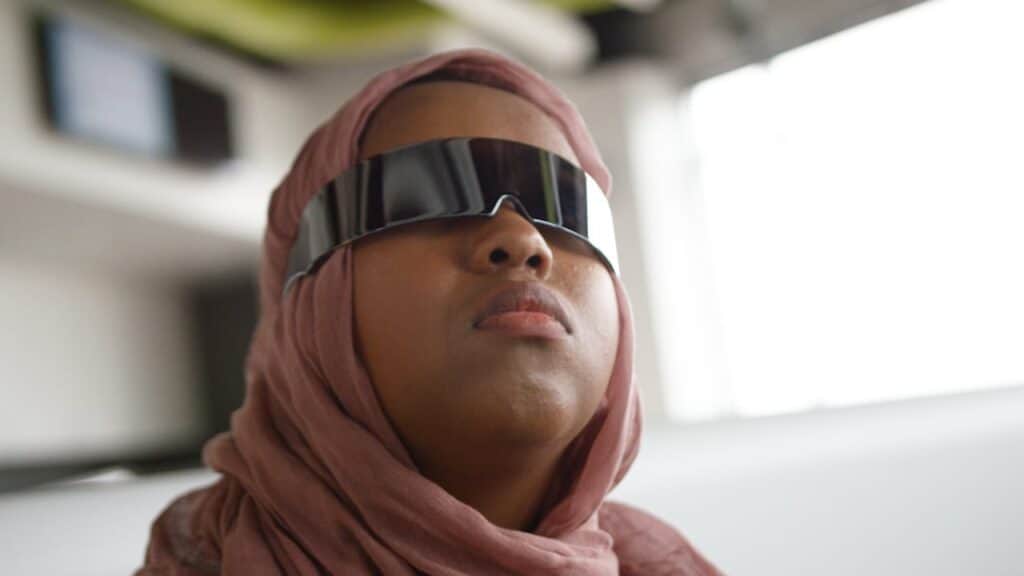 student with reflective glasses looking to the distance