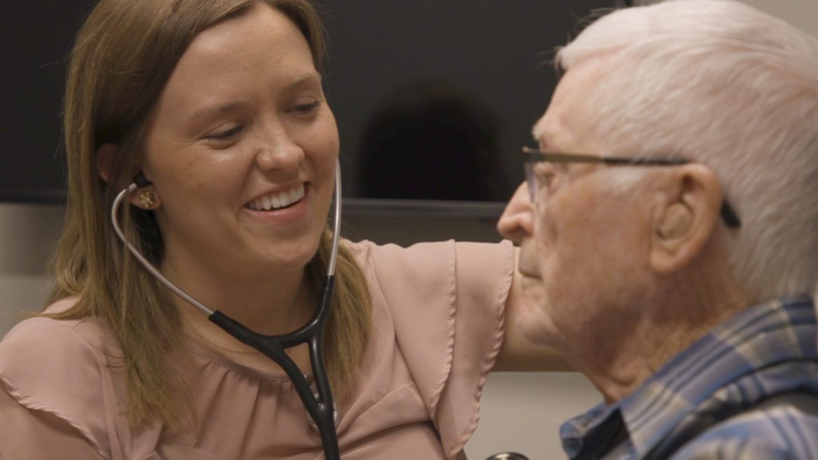 A medical student examines a patient