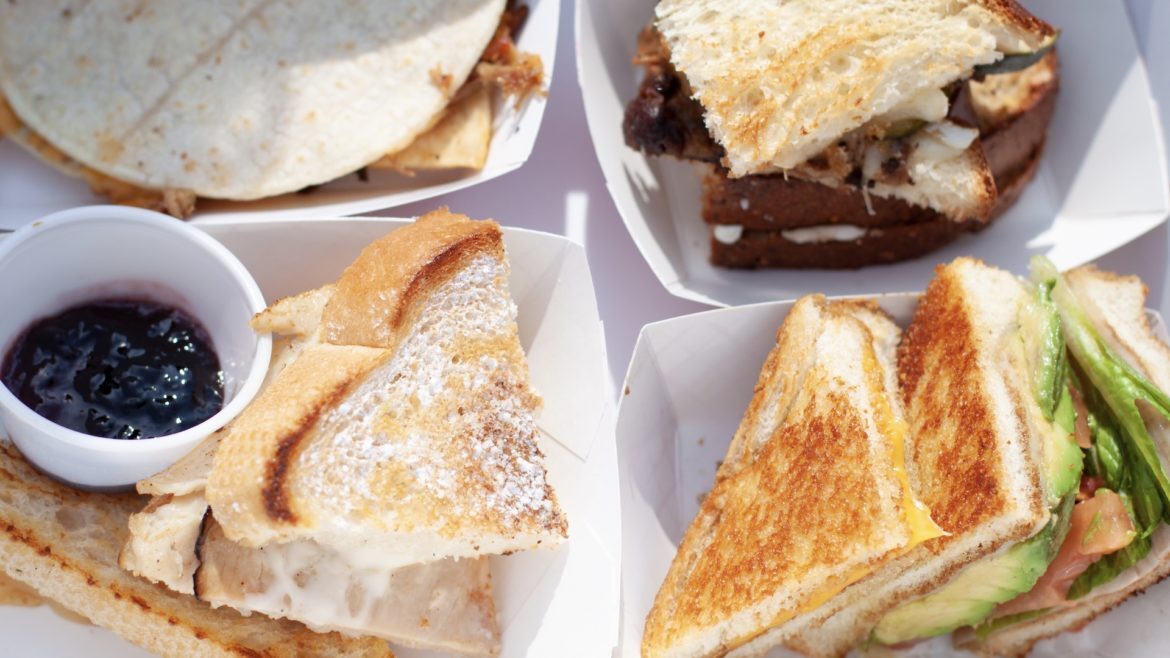 Four grilled cheese sandwiches on a tray