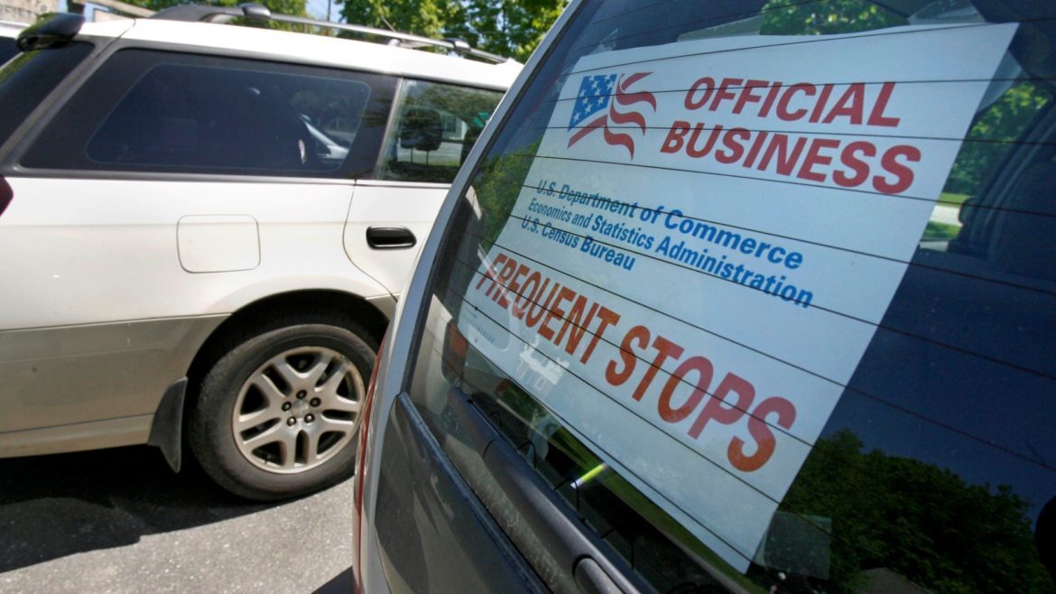 A sign marks the vehicle of a census enumerator.