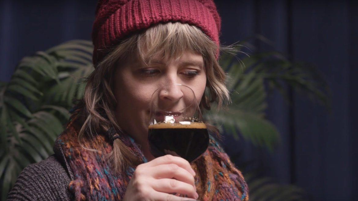 Beer enthusiast Cassie Niemeyer checks out a high alcohol content beer.