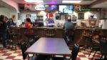 St. John's Catholic Club members hang out around the bar.