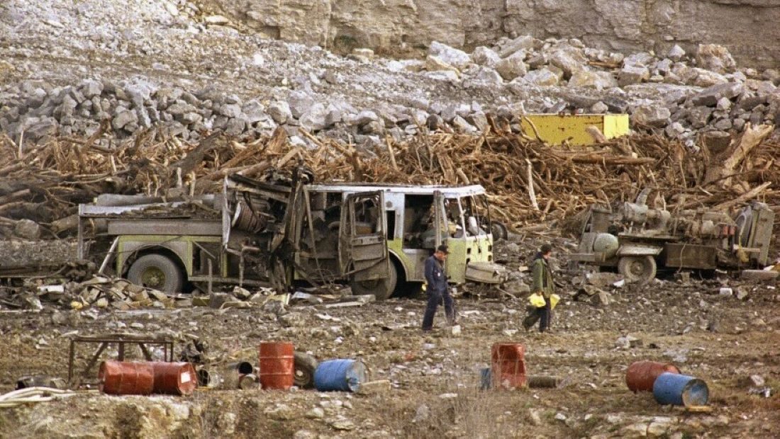 Investigators search through a highway construction site, Nov. 29, 1988, in Kansas City, where explosions shattered windows over a 10-mile area and killed six firefighters.