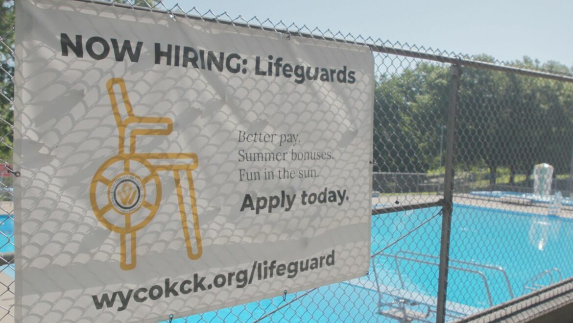 A "now hiring" sign at Parkwood Pool in Kansas. City, Kansas