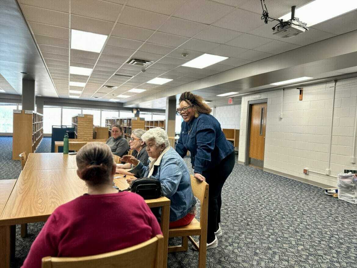 A crowd surrounds Kim Riley, parent and founder of the Transition Academy. For the past several years, her focus has been to build a network that better assists families whose children have developmental or intellectual disabilities find meaningful careers.