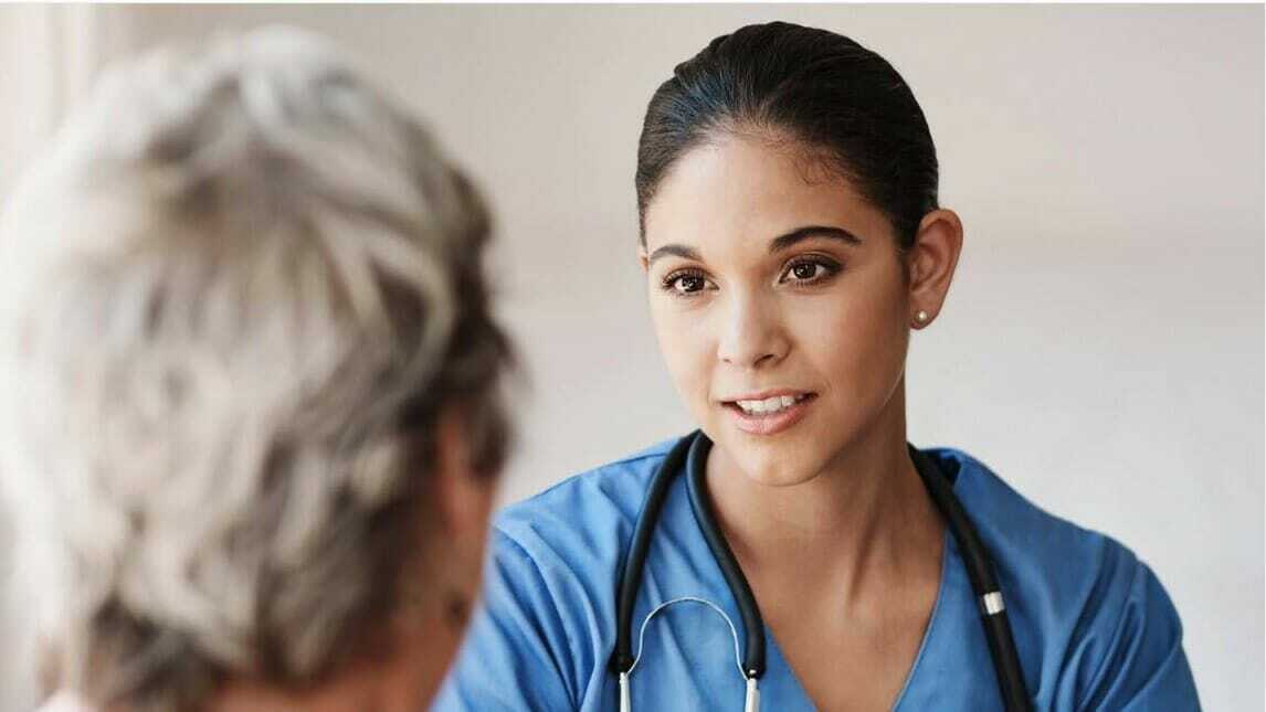 A caregiver meets with a patient.