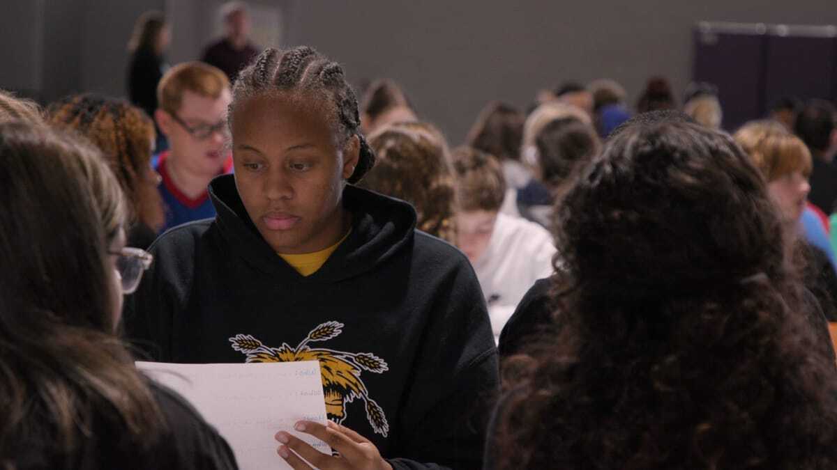 Teen students reviewing papers