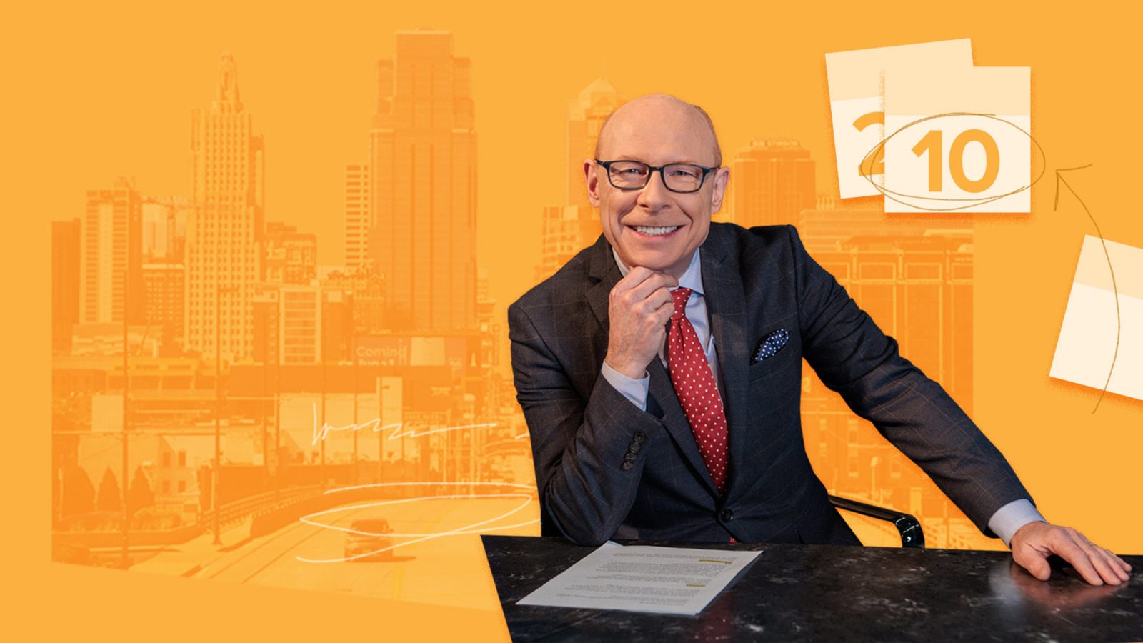 Nick Haines sitting at desk with downtown Kansas City in background and calendar pages with arrow circling date.