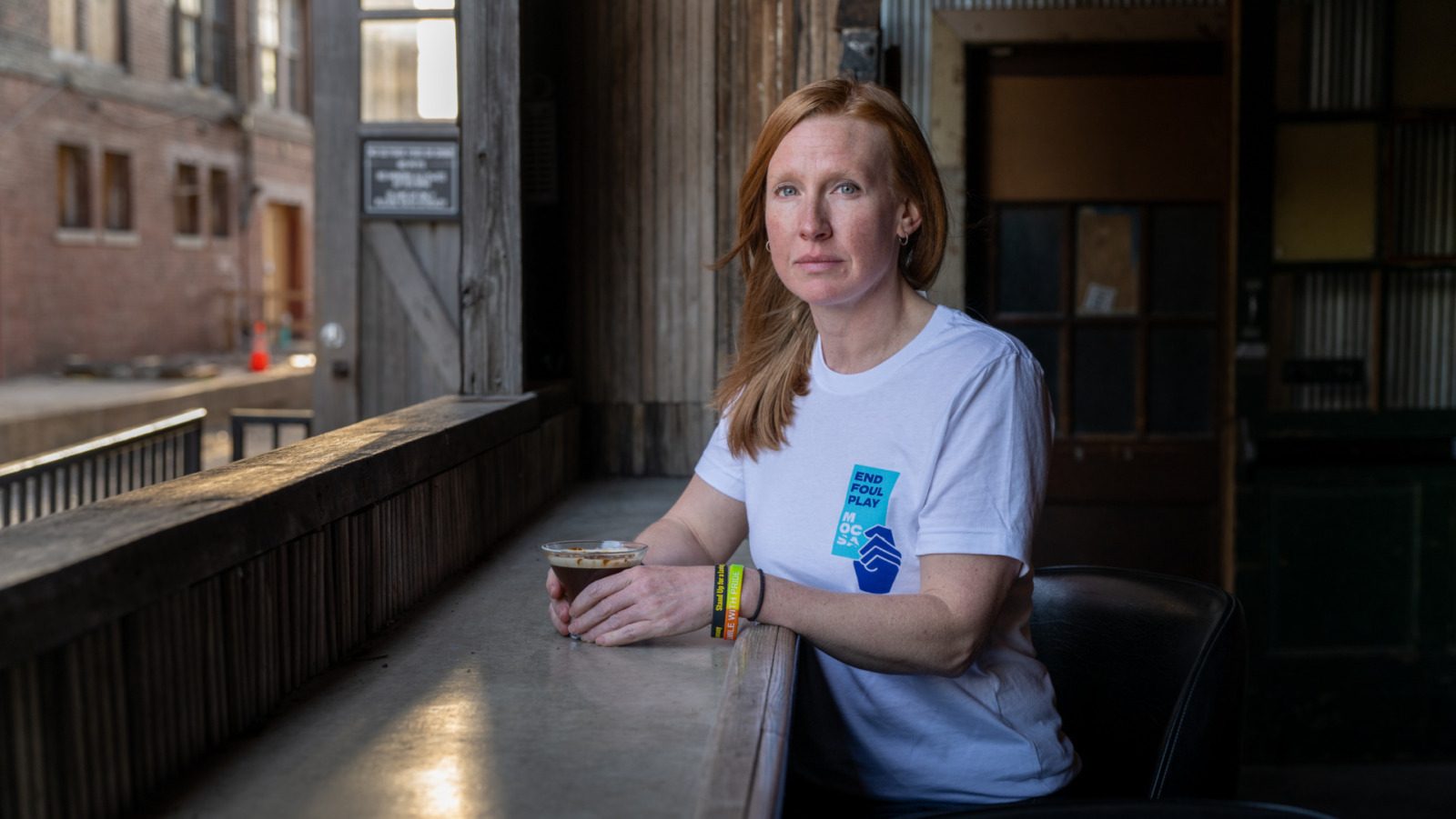 Jennifer Kabler is a sexual assault survivor who volunteers with the Metropolitan Organization Countering Sexual Assault (MOCSA), based in Kansas City, Missouri. She is photographed here at The Ship, a restaurant and bar in the West Bottoms, at a Sexual Assault Awareness Month Day of Action Celebration on April 7, 2026.