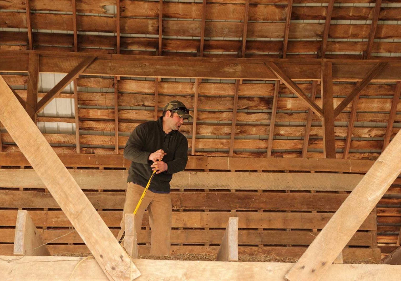 Farmer Levi Greuel spends a sunny Saturday afternoon fixing up his farm equipment and tearing down an old wooden barn in preparation for planting season. (Photo: Abby Wendle/Harvest Public Media)