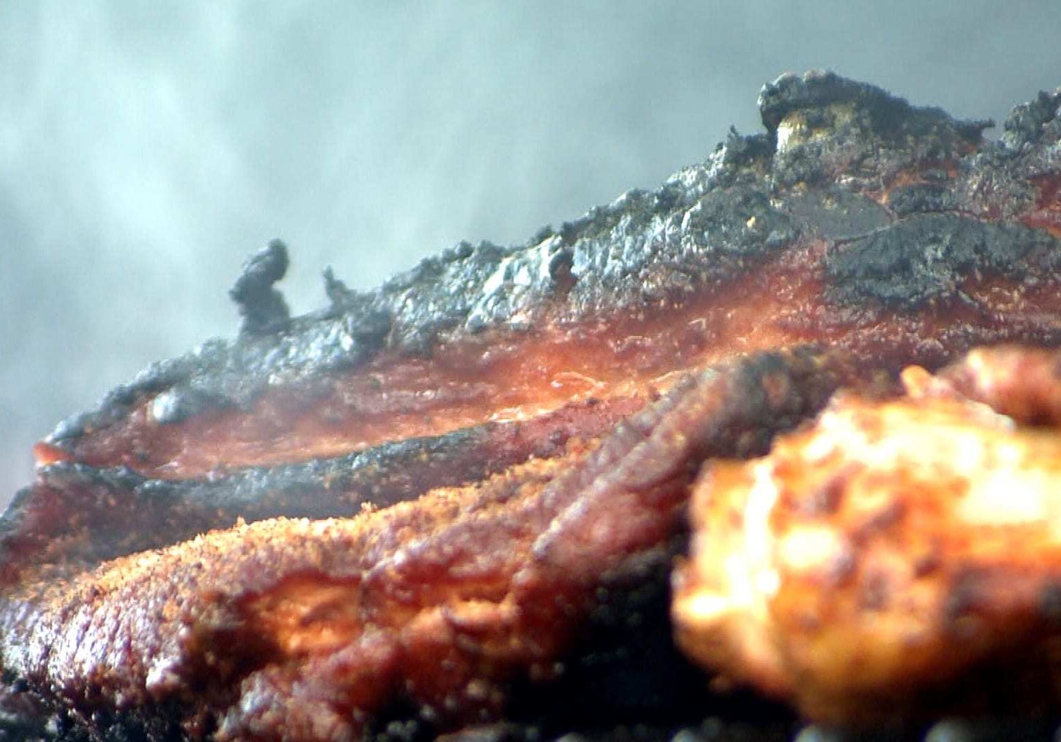 Ribs and chicken sizzle over charcoal at the “Ribstock” barbecue contest in Millard, Neb. (Photos: Brian Seifferlein | Harvest Public Media)