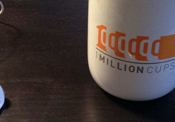 1 Million Cups logo with mug and heaphones